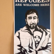 Pro-refugee fliers decorate the walls of the MIRA office.