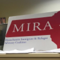 The logo for MIRA is displayed proudly next to a voter registration sign.